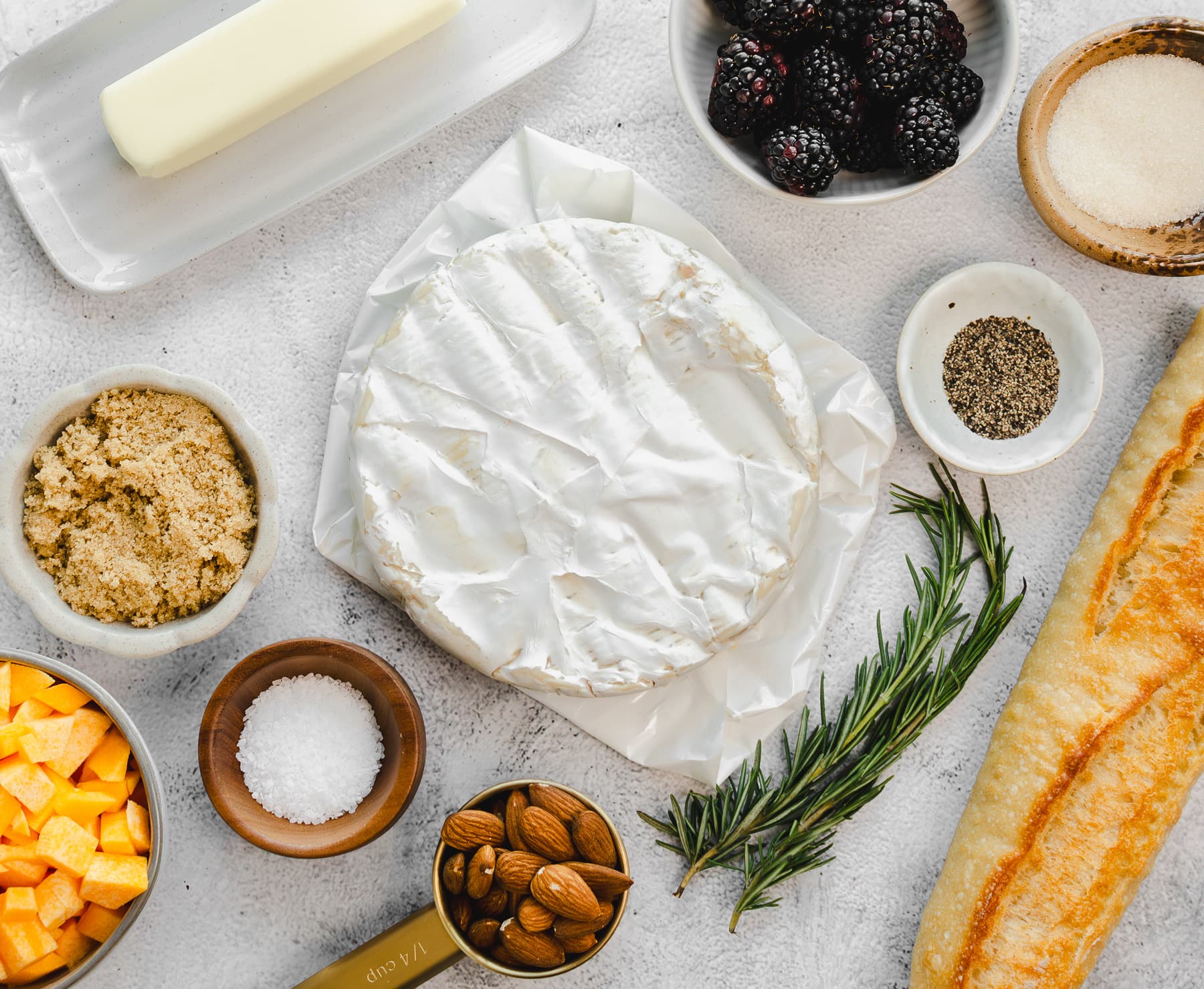 Ingredients for a Brie brûlée with butternut squash and toffee almonds appetizer.